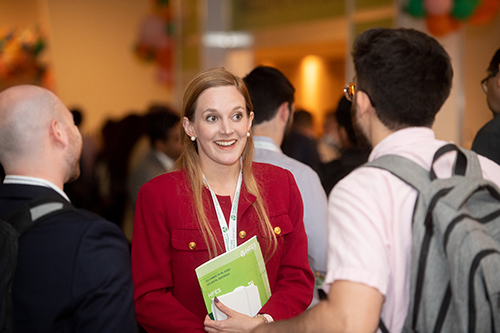 Smiling woman talking with a group of people